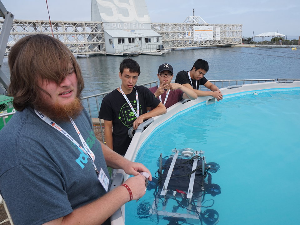 The team tests the submersion capabilities of the Seagoat at a staging pool during the international RoboSub competition
